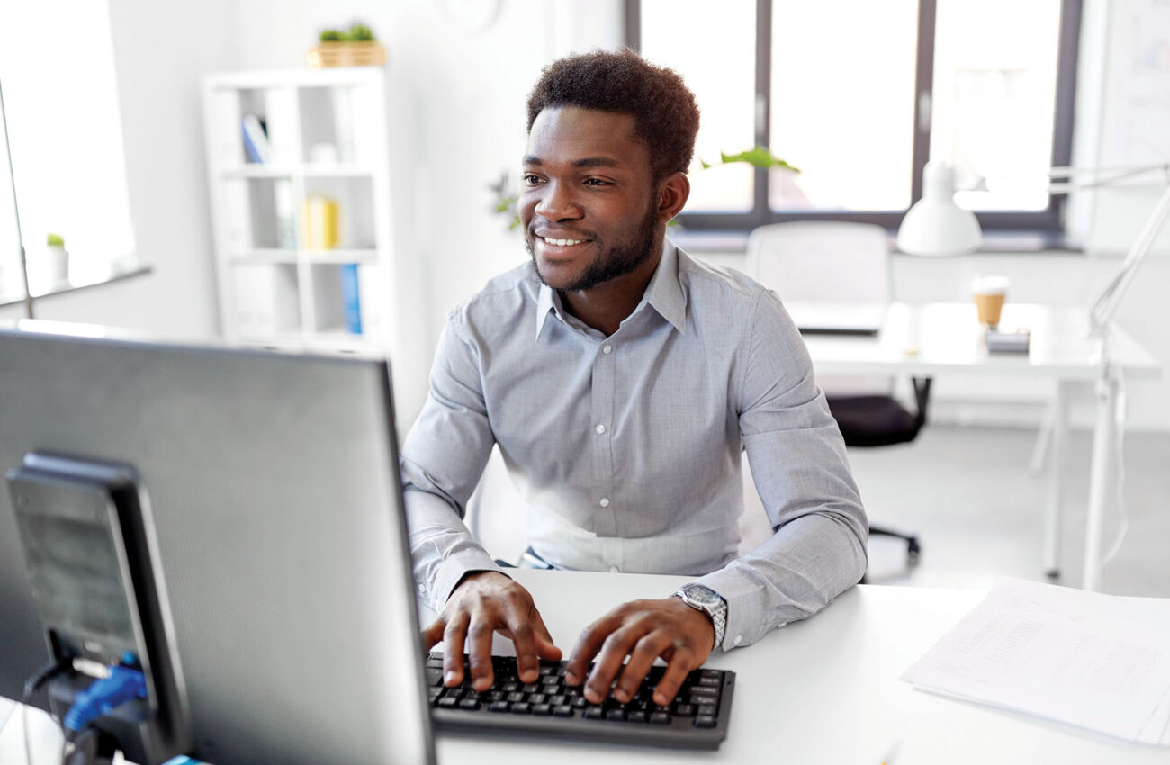 african businessman works with computer at office