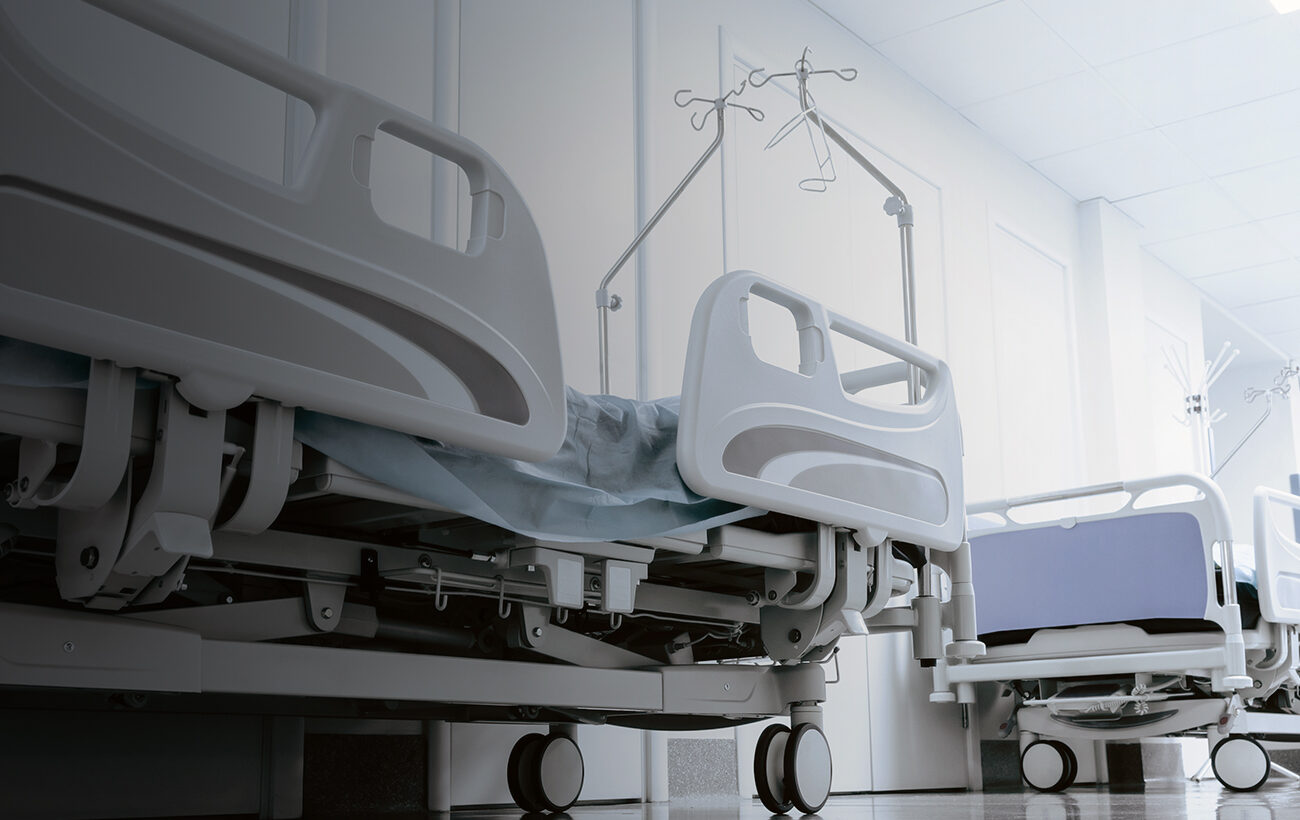 long corridor in hospital with surgical beds.